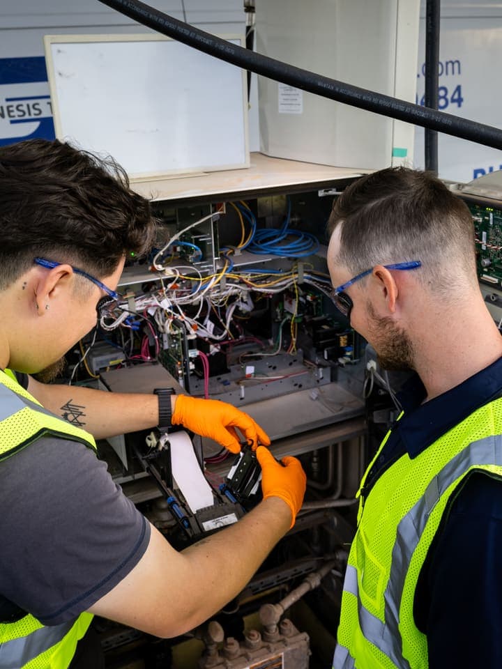 Two GTI techs working inside a dispenser